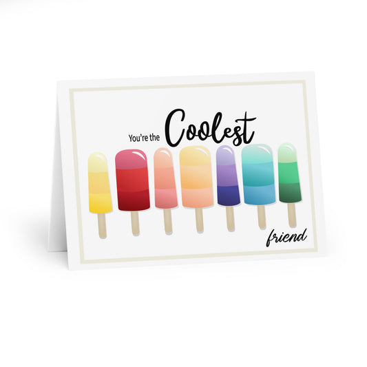 Popsicles in rainbow colors lined up on a greeting card with You’re the Coolest Friend sentiment. 