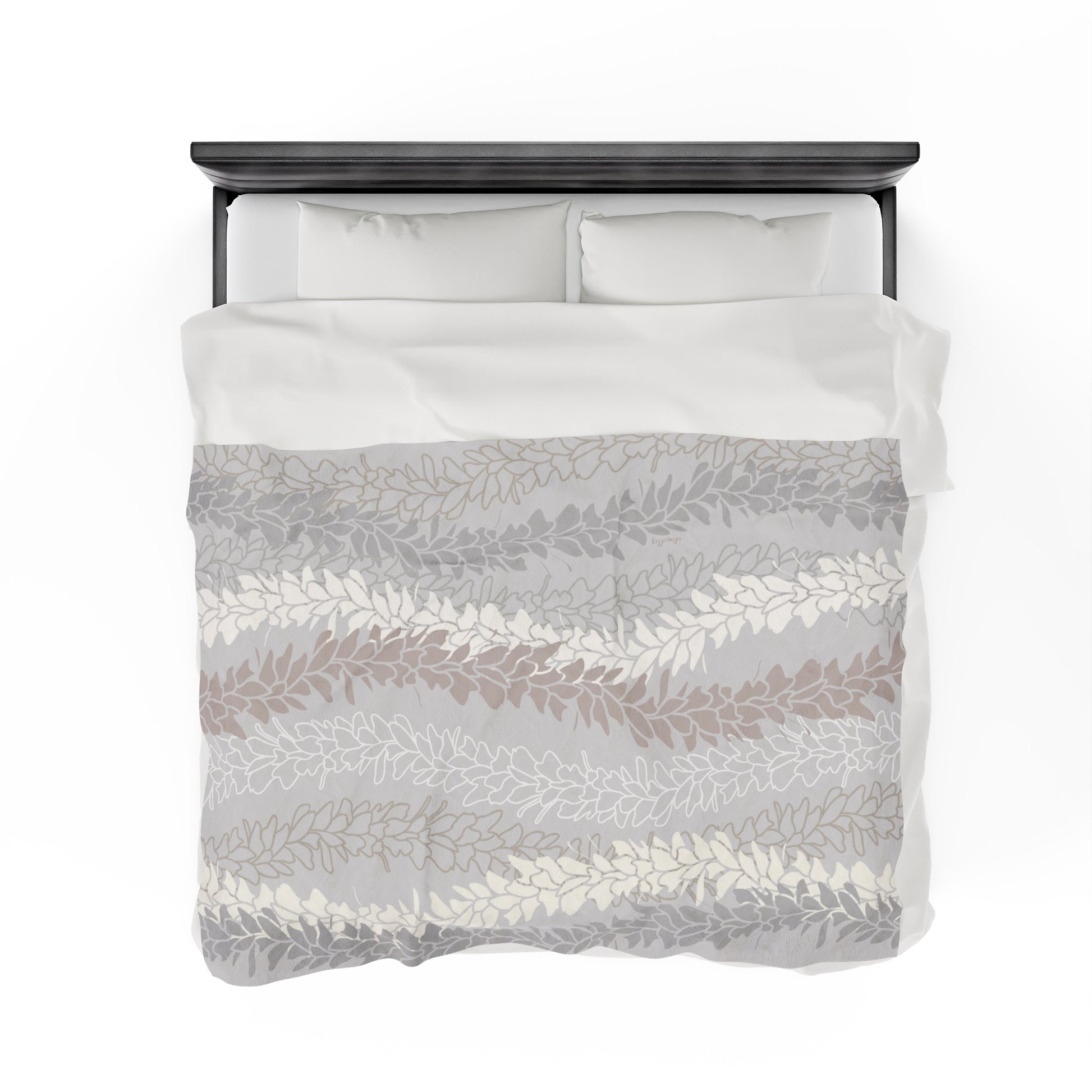 Gray microfiber blanket with Hawaiian flower lei design of butterfly ginger awapuhi in cream, tan and gray silhouettes and outlines.  Blanket draped on a double bed with white bedding and dark brown gray headboard.