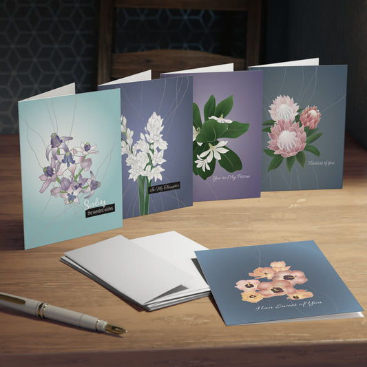5 pack Hawaiian flower greeting cards in feminine blue and purple colors with sentiments sending warm wishes, you’re my person, thinking of you, Hau sweet of you and In my thoughts.
