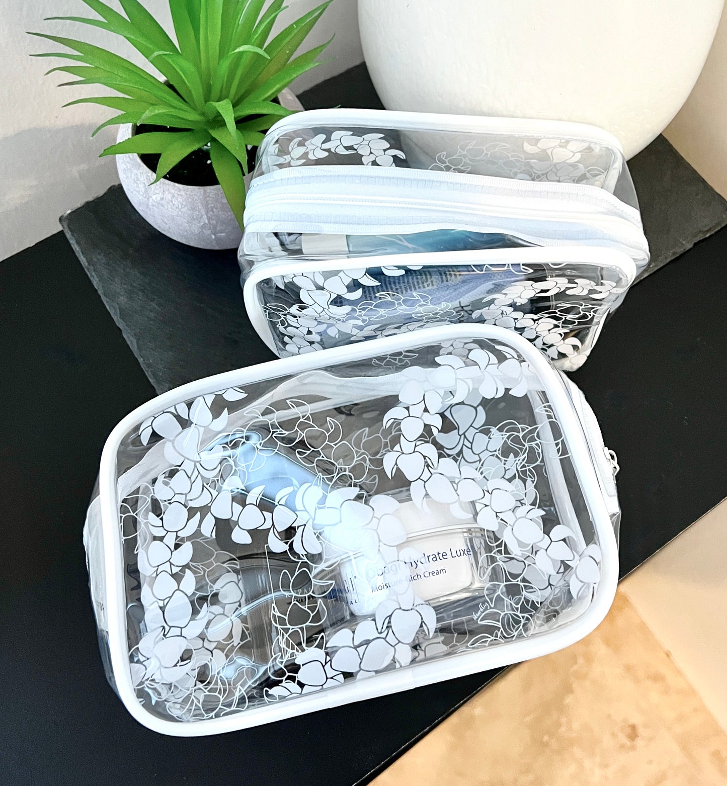 Small and Medium Puakenikeni lei clear pouches fits cosmetics, travel size hair spray, sunscreen.