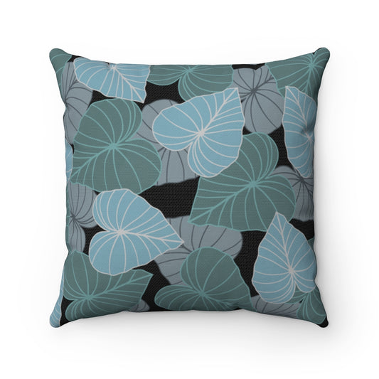 Canvas throw pillow cover with layered blue, gray and teal Kalo leaves on a black background.