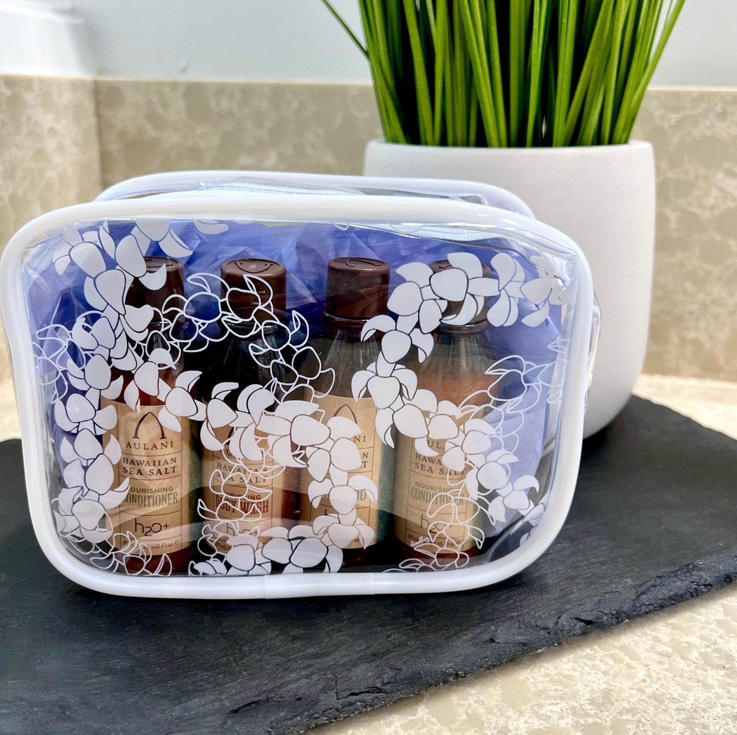 Small puakenikeni lei clear pouch fits all your travel size bottles.  