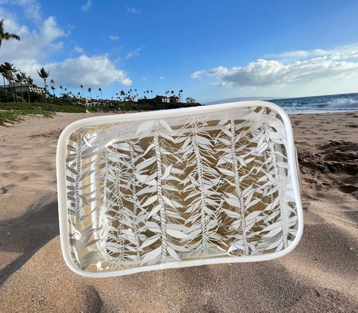 Ti_leaf_lei_clear_zippered_pouch_cosmetic_bag on sandy beach