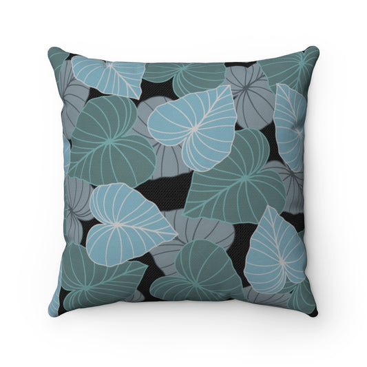 Canvas throw pillow cover with layered blue, gray and teal Kalo leaves on a black background. 