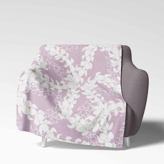 Soft velveteen blanket with a design displaying multiple Puakenikeni flower lei strands in white silhouettes and line art on a pinky periwinkle background.
