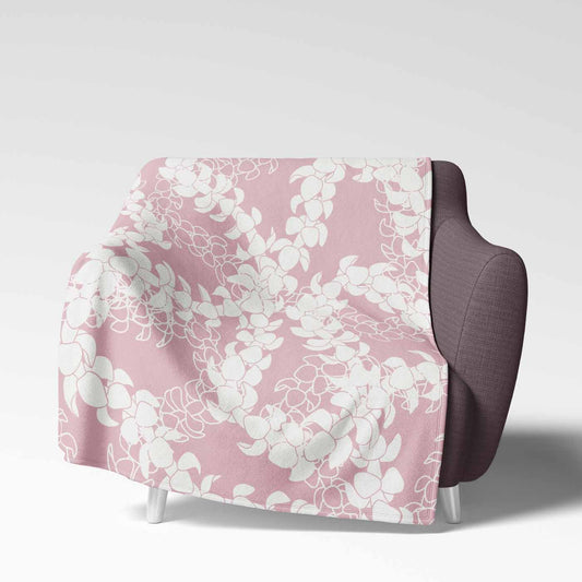 Soft velveteen blanket with a design displaying multiple Puakenikeni flower lei strands in white silhouettes and line art on a rosey pink background.