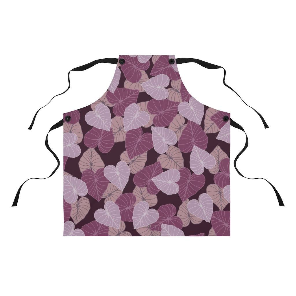 Chef apron with all over print design in varying pink and mauve Kalo leaves on a maroon background. 